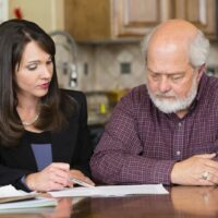 Personal Injury Lawyer Helping Elderly Man With Paperwork Stock Photo Personal Injury Lawyer Helping Elderly Man With Paperwork Stock Photo