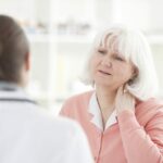 Elderly Woman With A Whiplash Injury Stock Photo