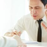 Businessman Telling Another Person To Stop Stock Photo