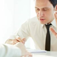 Businessman Telling Another Person To Stop Stock Photo