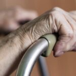 Elderly Woman Using A Walker Stock Photo