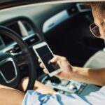 Young Man Texting While Driving Stock Photo