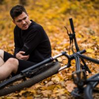 man near his bicycle after an accident